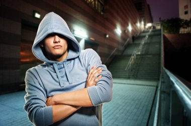 Young handsome men in a hood outdoors clipart