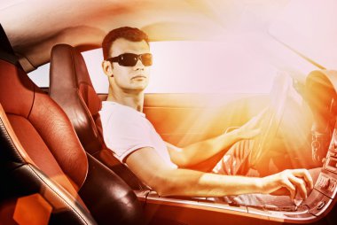 young man driving modern sport car clipart