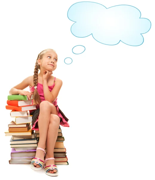 Pequena estudante sentada em livros — Fotografia de Stock