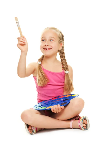 Beautiful little girl with a paintbrush — Stock Photo, Image