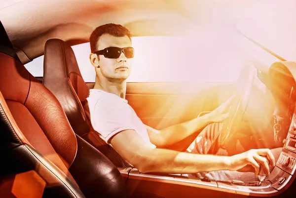 Young man driving modern sport car — Stock Photo, Image
