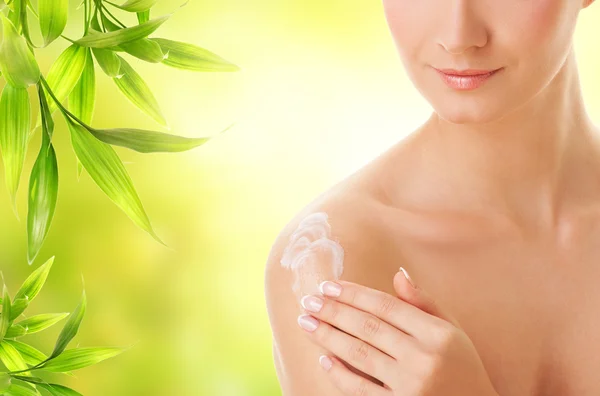 Dama aplicando crema hidratante a su piel —  Fotos de Stock