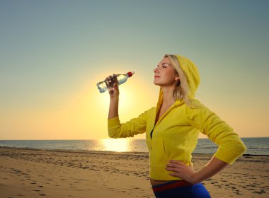 Young woman drinking water after fitness clipart