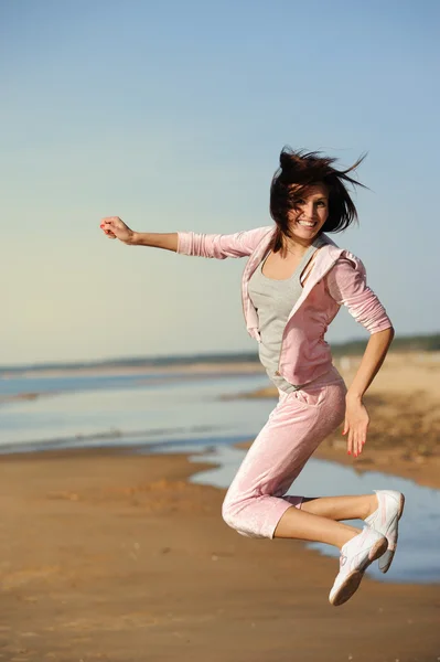 Женщина прыгнула на пляж — стоковое фото