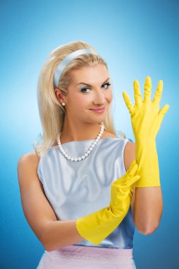 Happy housewife with rubber gloves clipart