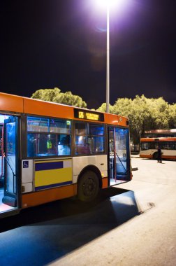 Bus station at night clipart