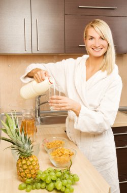 Beautiful woman making breakfast clipart