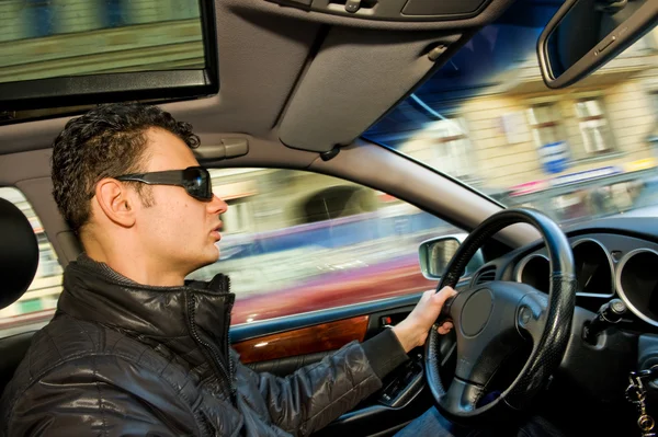 Handsome young man driving a car — Stock Photo, Image