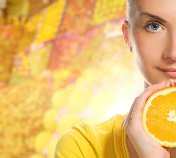 Güzel bir genç kadın olgun portakal ile — Stok fotoğraf