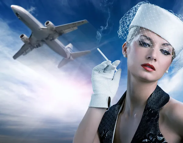 Sexy stewardess and flying plane — Stock Photo, Image