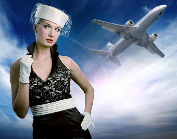 Sexy stewardess and flying plane — Stock Photo, Image