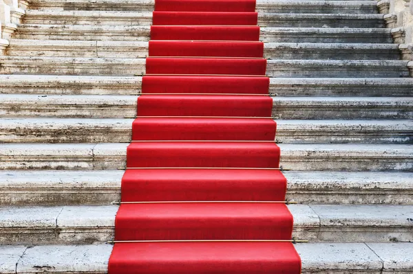 Ancient stairs covered with red carpet — Stock Photo, Image