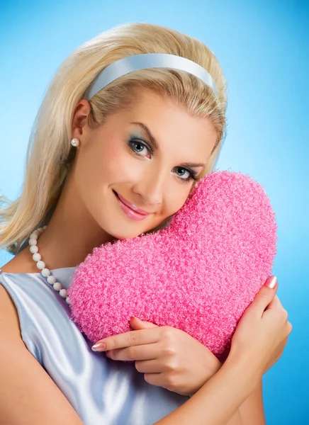 Beautiful woman with fluffy heart pillow — Stock Photo, Image
