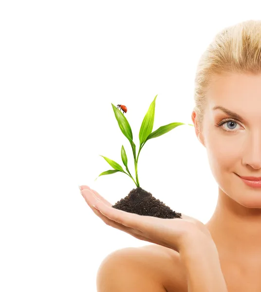 Beautiful woman holding young plant — Stock Photo, Image