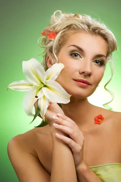 Beautiful young woman with lily flower Royalty Free Stock Photos