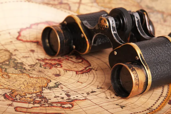 Old binoculars on antique map Royalty Free Stock Images