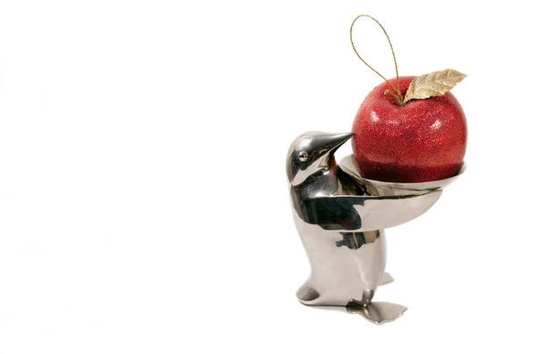 Penguin offering an apple ornament — Stock Photo, Image