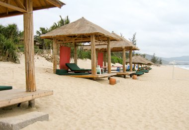 Cabanas on a sandy beach clipart
