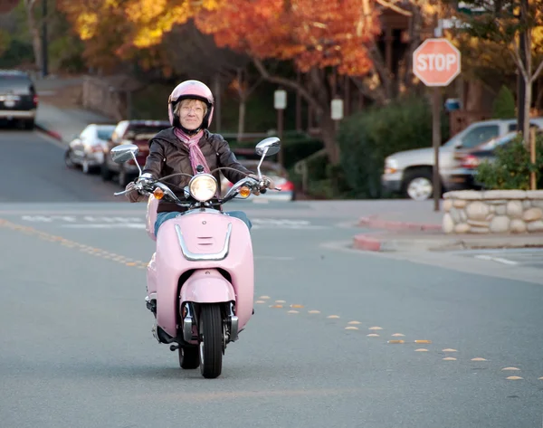 stock image Lady biker on pink scooter