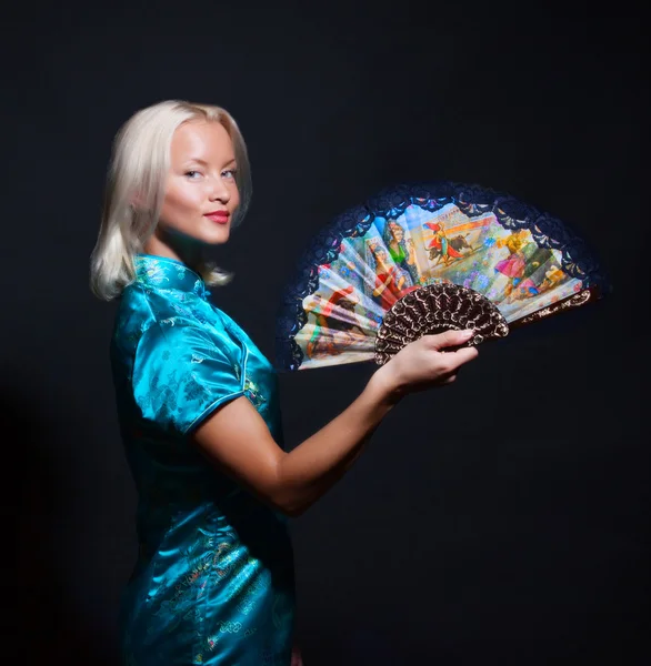 Portrait of young woman with fan — Stock Photo, Image