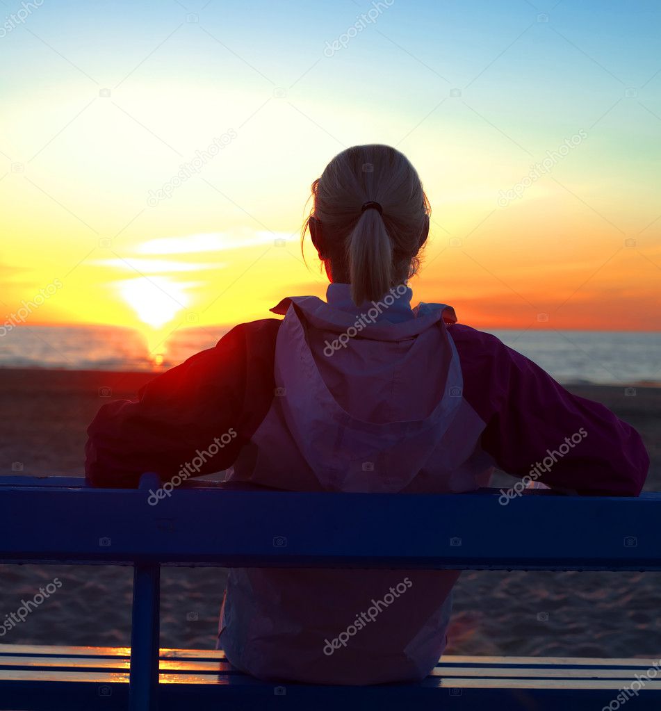 Athlete on the beach watching sunset