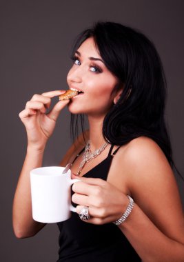 Attractive brunette drinking tea clipart