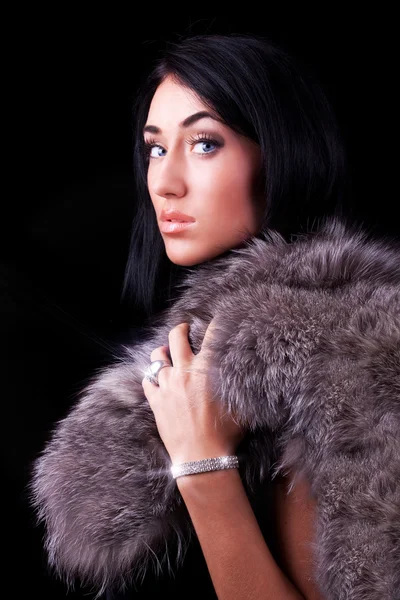 Beautiful brunette holding her coat — Stock Photo, Image