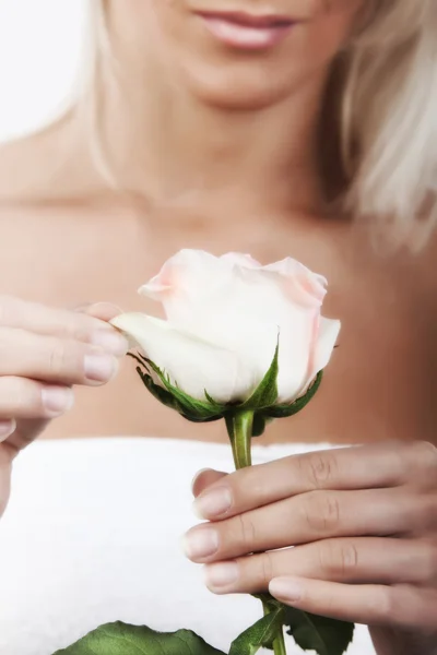 Blondine in der Hand einer Rose — Stockfoto