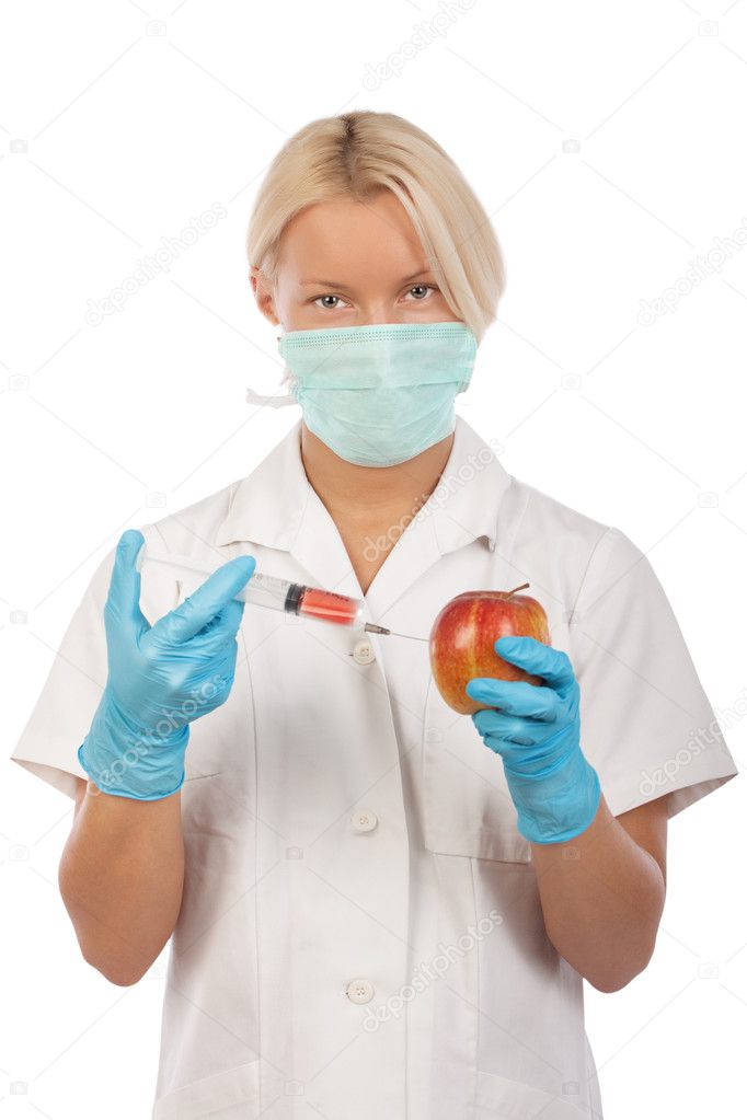 Nurse is making injection in apple