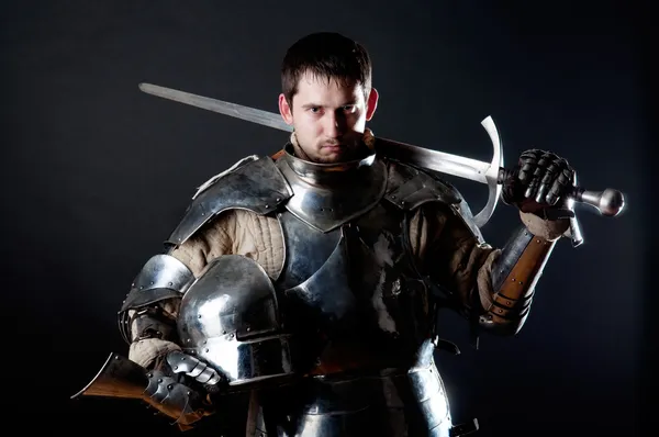 Knight holding sword and helmet — Stock Photo, Image