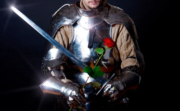 Knight looking at flower — Stock Photo, Image