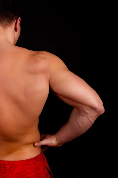 Athlete is showing his muscles — Stock Photo, Image