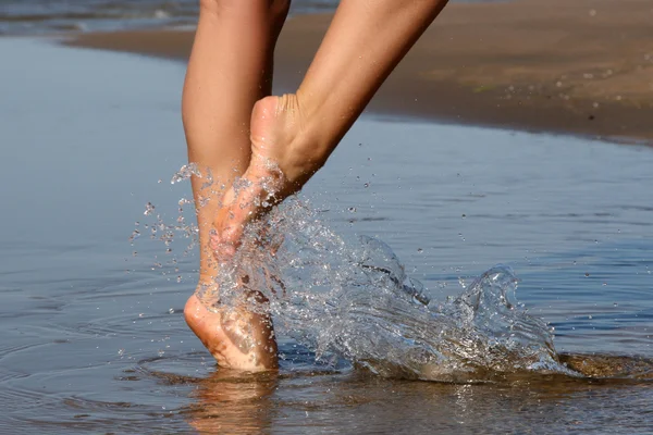 Nice legs walking in water — Stock Photo, Image
