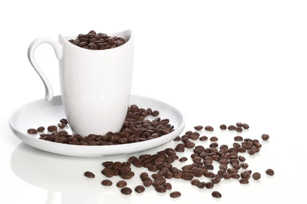 stock image Cup, plate and coffee in grains