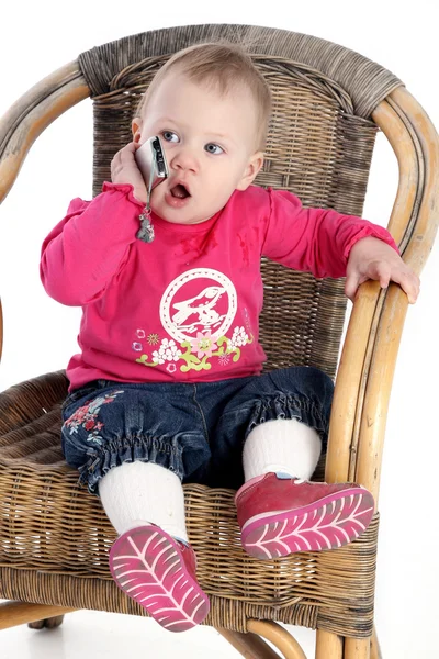 Little girl speaks by a mobile phone — Stock Photo, Image