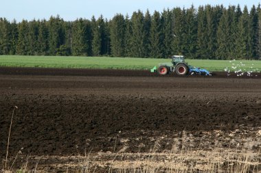 Tractor works in the fields clipart