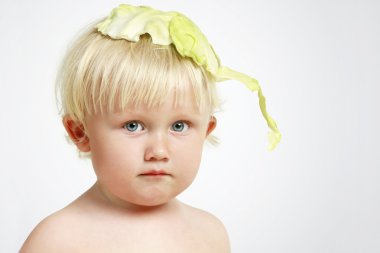 Boy with cabbage sheet (soft focus) clipart