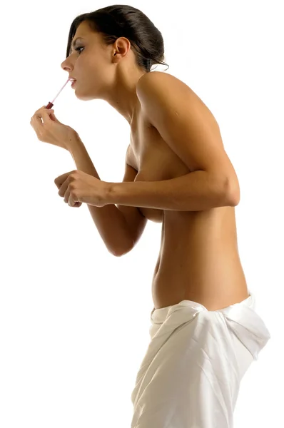 Woman in towel is making up — Stock Photo, Image