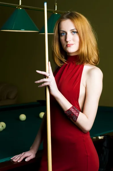 Woman in red with cue — Stock Photo, Image