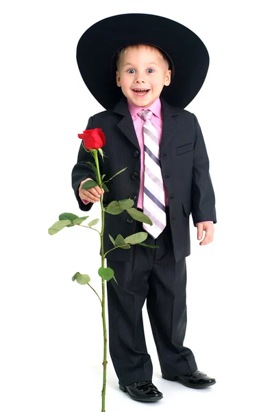 Усміхнений хлопчик з трояндою — стокове фото