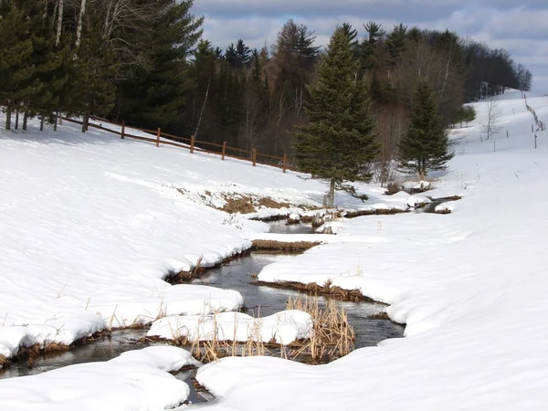 Meandering stream in snow — Stock Photo, Image