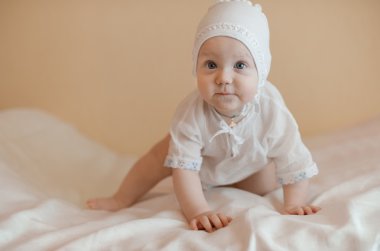 Cute child crowling in the bed clipart