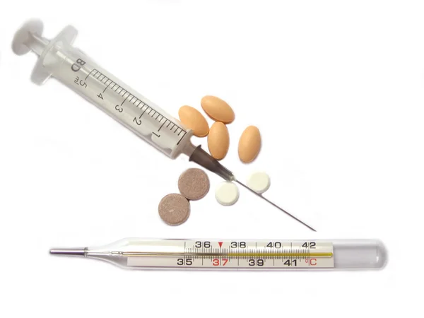 Syringe, tablets, a thermometer — Stock Photo, Image