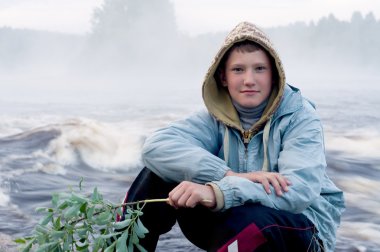 Boy on river bank clipart