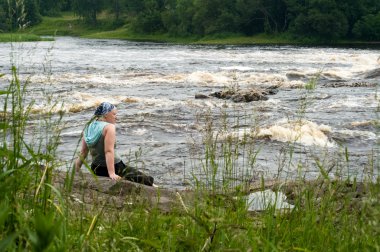 Woman on river bank clipart