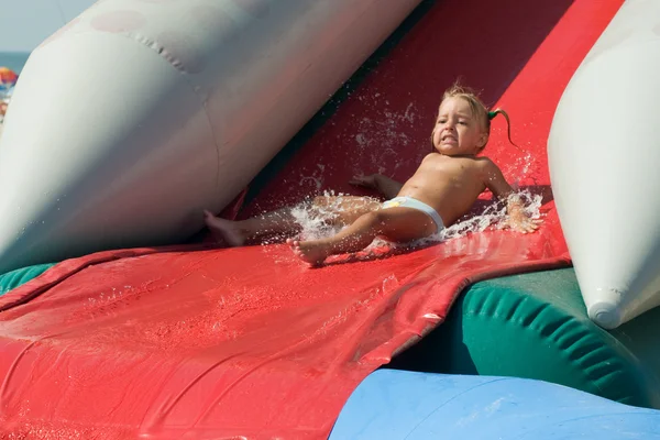 Girl on water slide — Stock Photo, Image