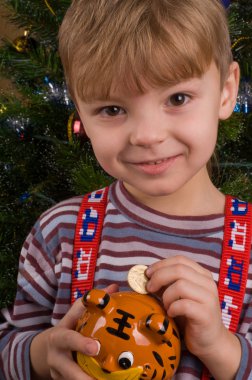 Boy with piggy bank clipart