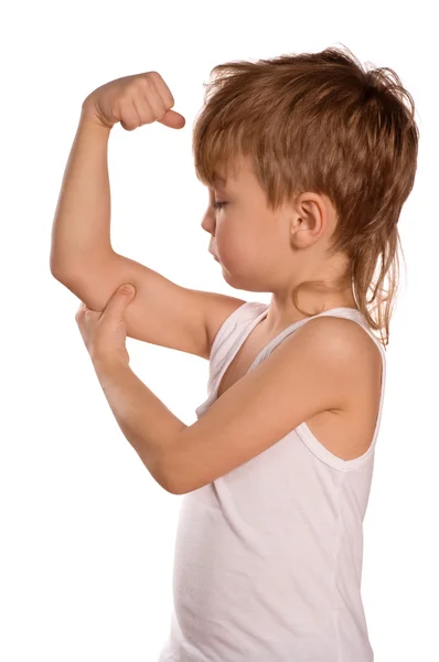Malý chlapec protahuje biceps — Stock fotografie