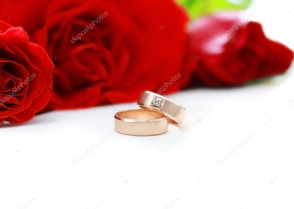 Two wedding rings and red roses