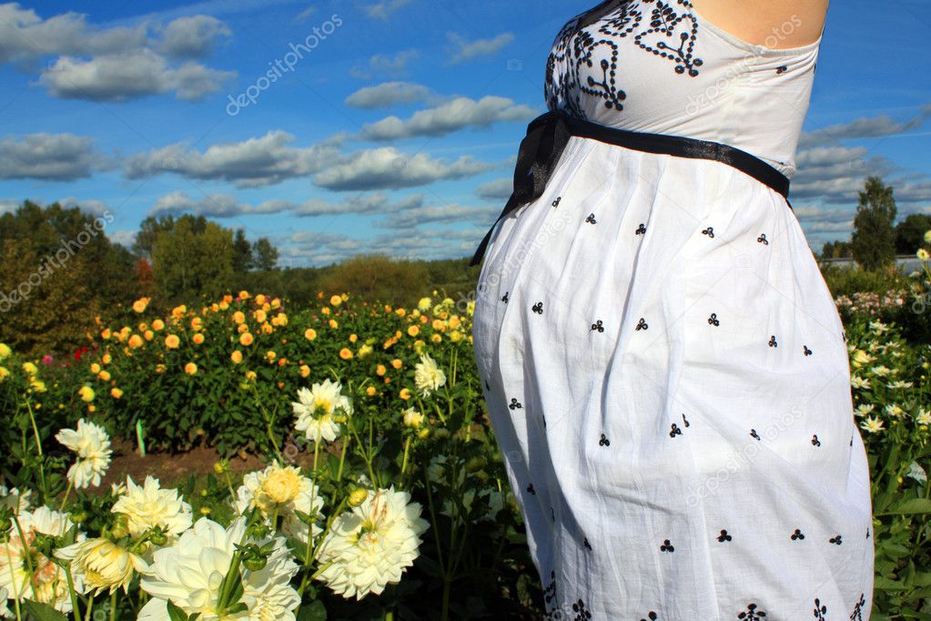Pregnant woman's belly in the park